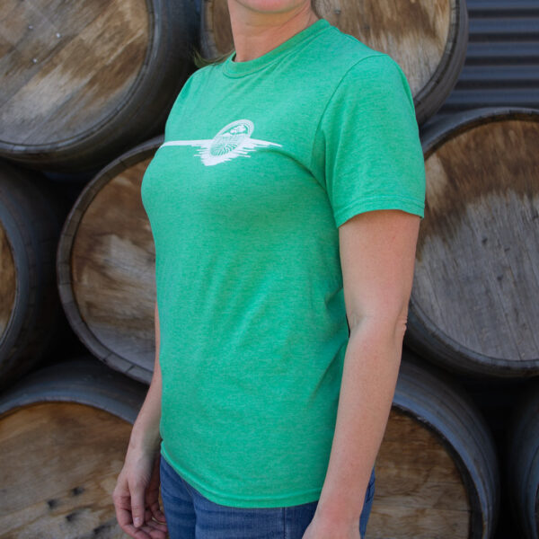 Green tee shirt with common roots logo