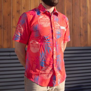 Pink button-down short sleeved hawaiin shirt with blue palm frond pattern