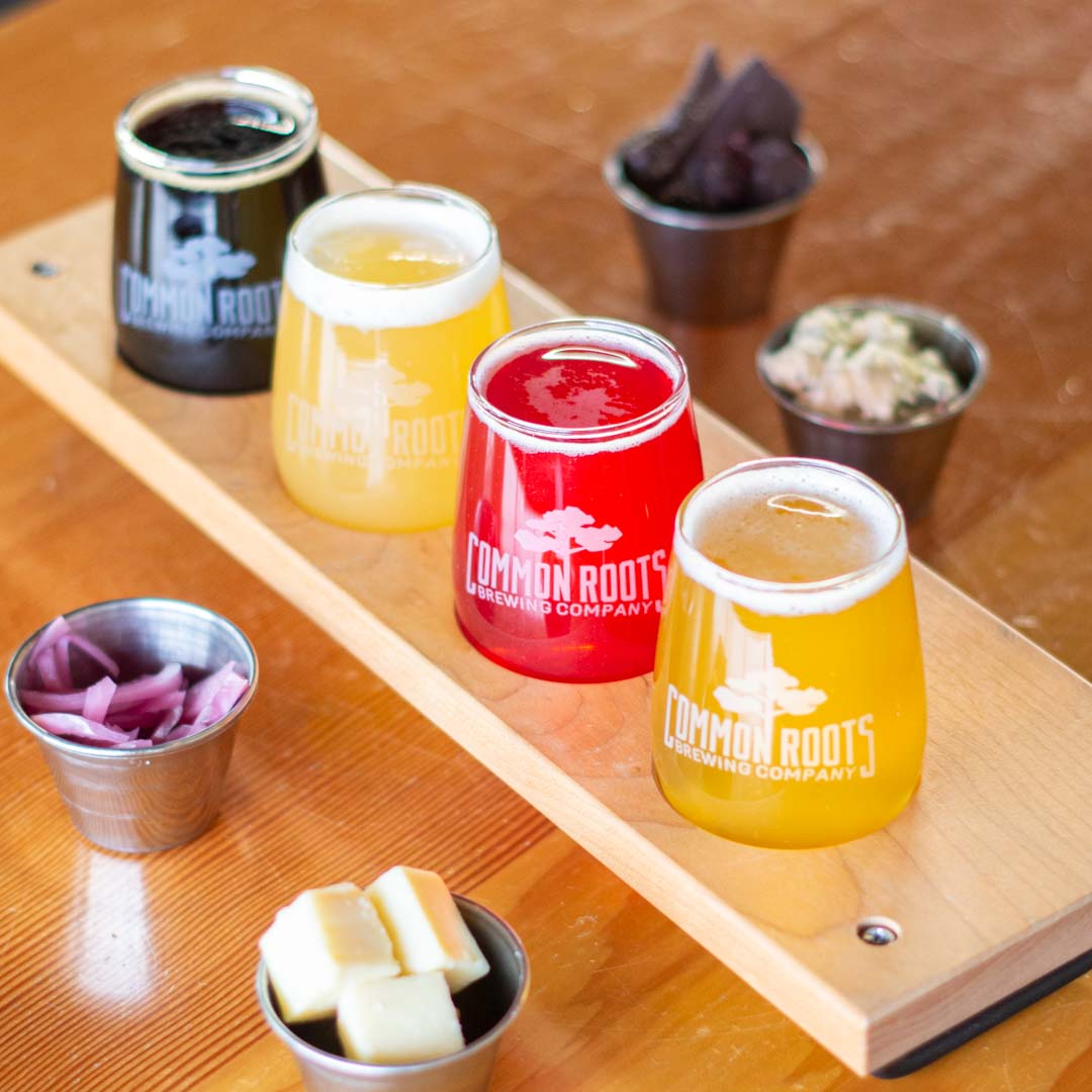 Flight of beer surrounded by small bites