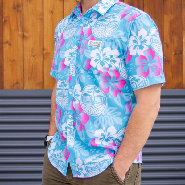 Teal button-down short sleeved hawaiin shirt with pink hibiscus flower pattern