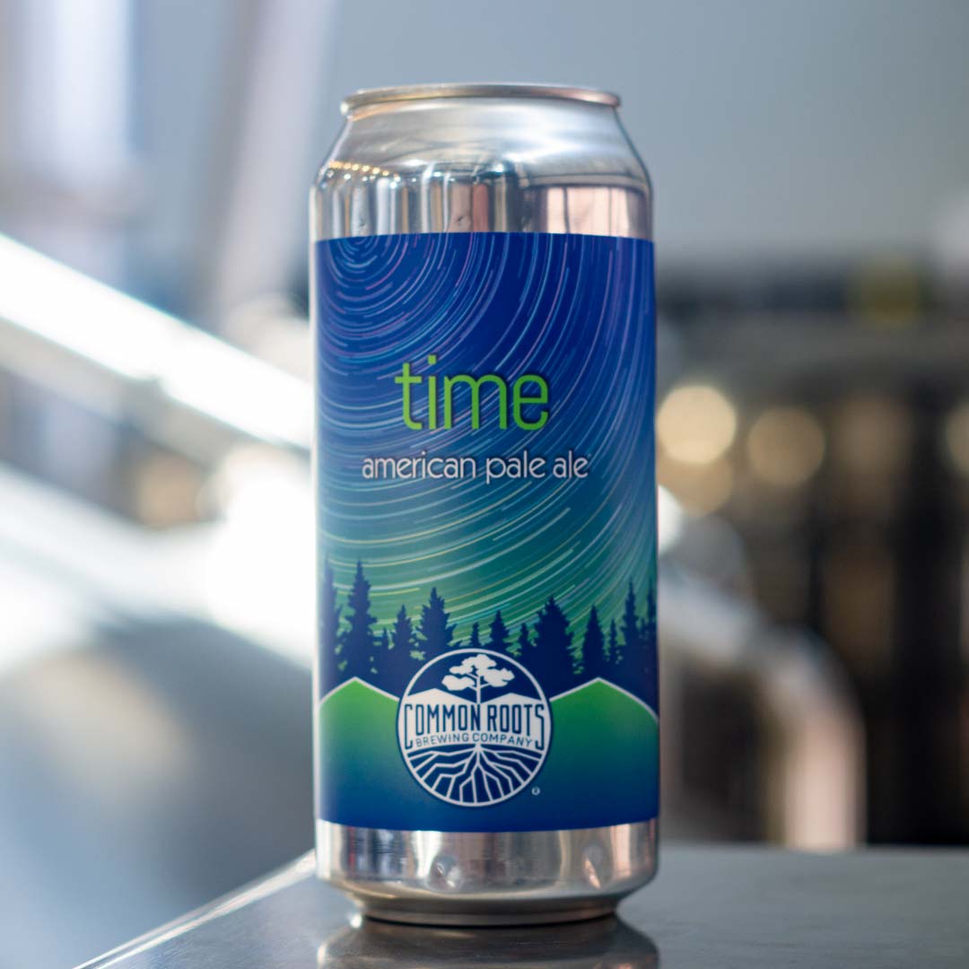 Can of Time with stainless steel brewing equipment in the background