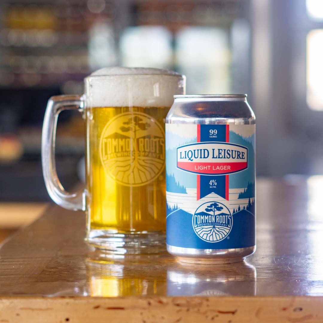 Can of liquid leisure next to a mug of golden colored beer