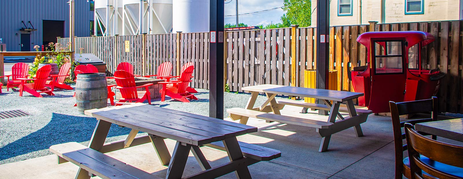 Biergarten with Adirondack chairs and picnic tables