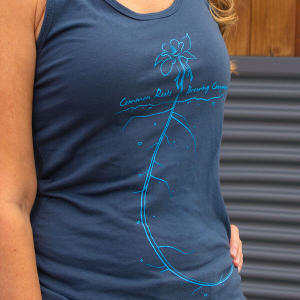 Close-up of flower vine graphic on blue tank top