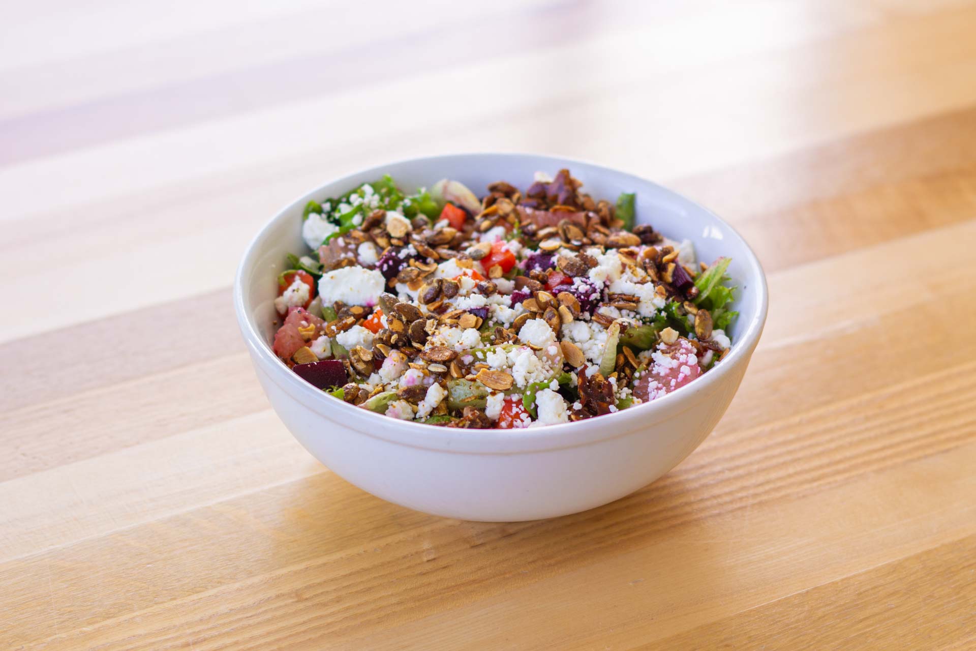 Beautiful and colorful salad on a wooden table.