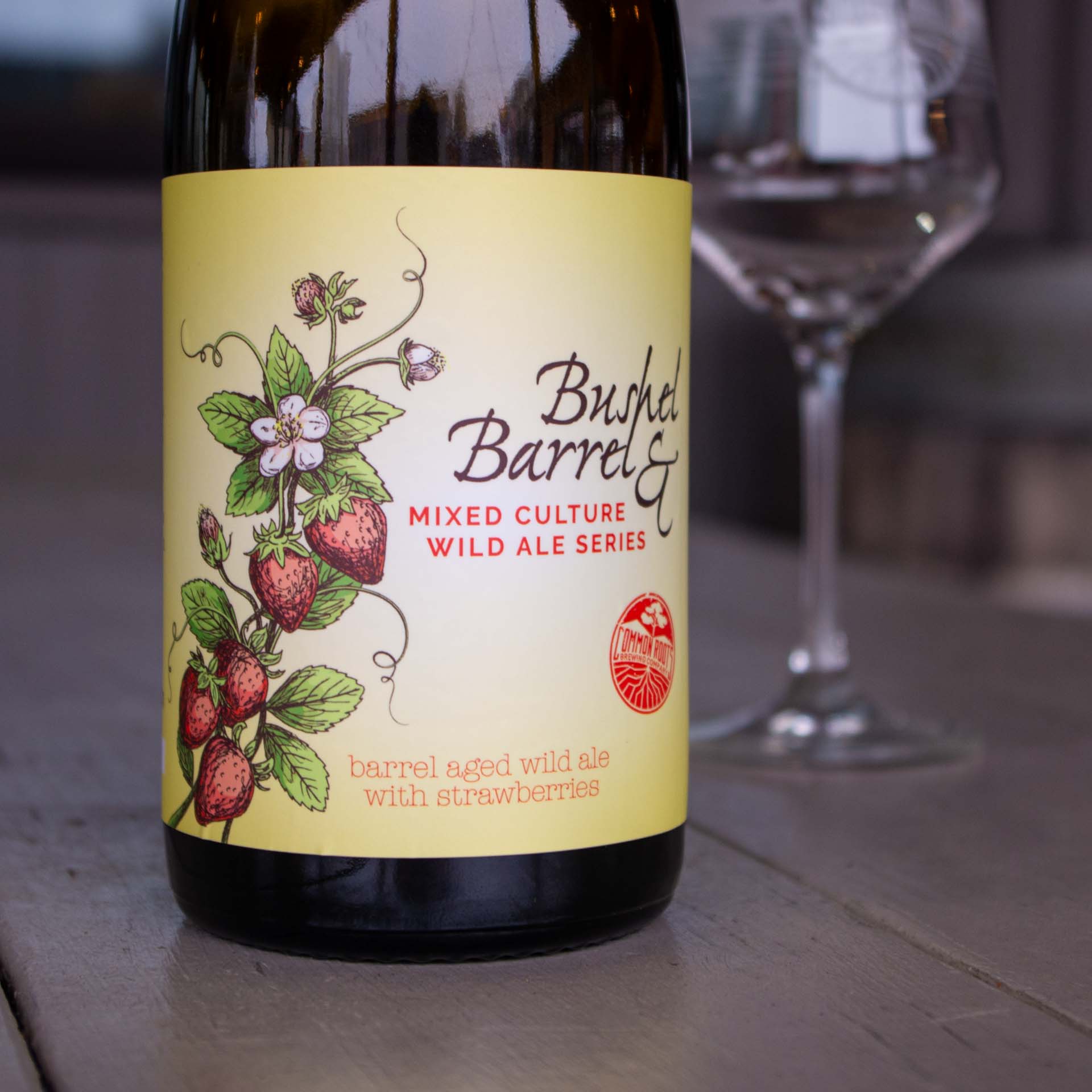 Bottle of beer with illustration of strawberry plant on the label