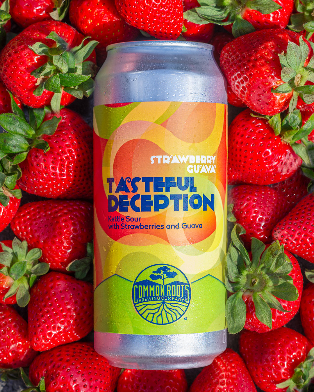 Can of Tasteful Deception laying on a pile of strawberries