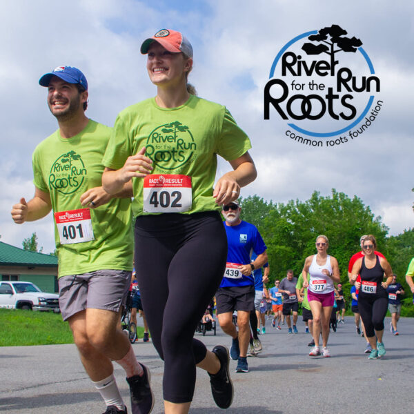 Runners running in the River Run for the Roots with logo overlay