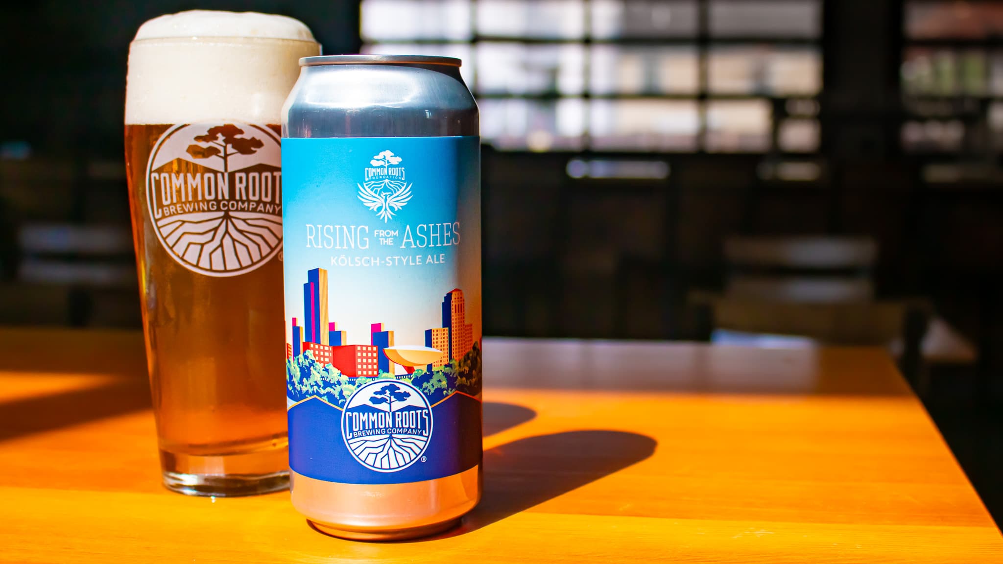 Can of Rising from the Ashes 2025 with a pour behind it