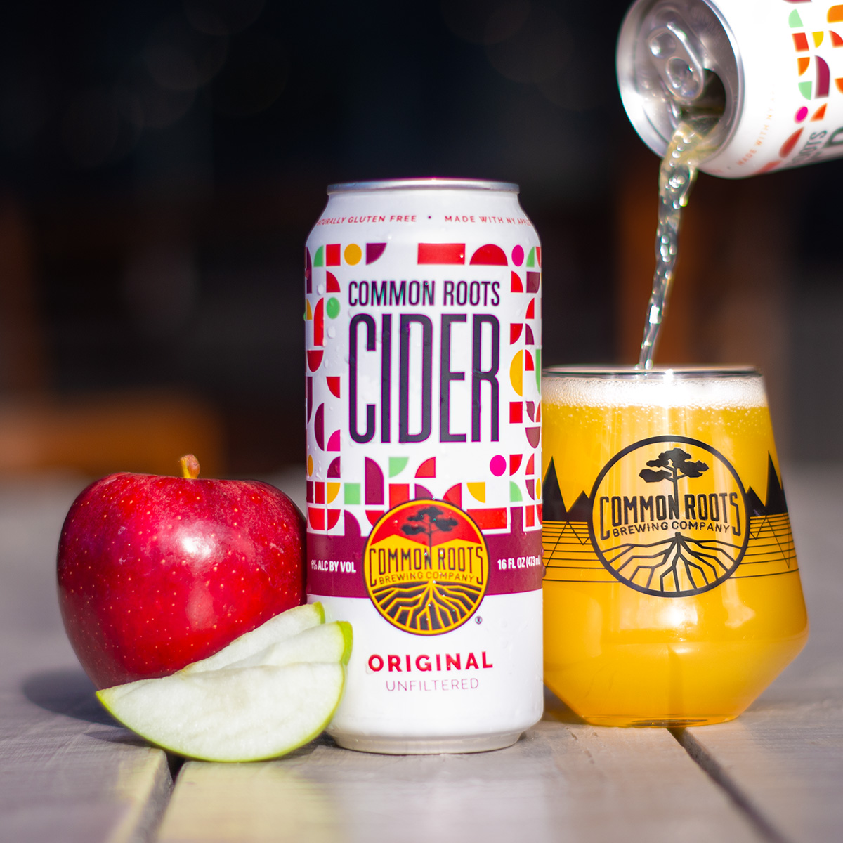 Cider can with a pour and apples