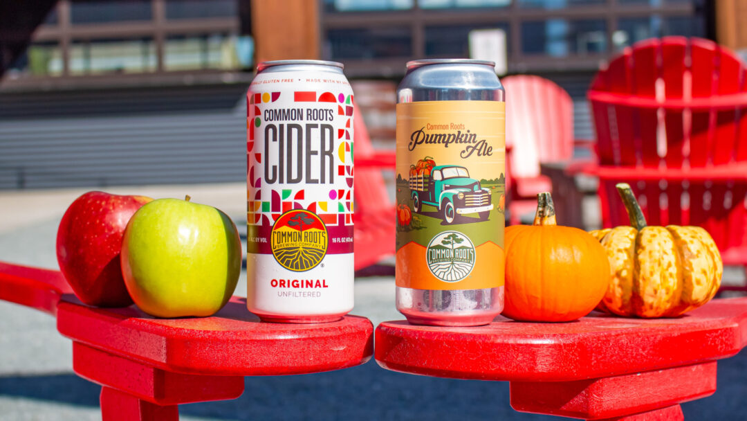 Fall beer cans on a red chair in the biergarten featuring Cider and Pumpkin Ale