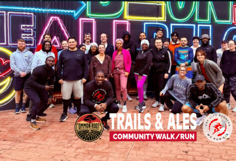 Runners Posing infront of a mural in Albany