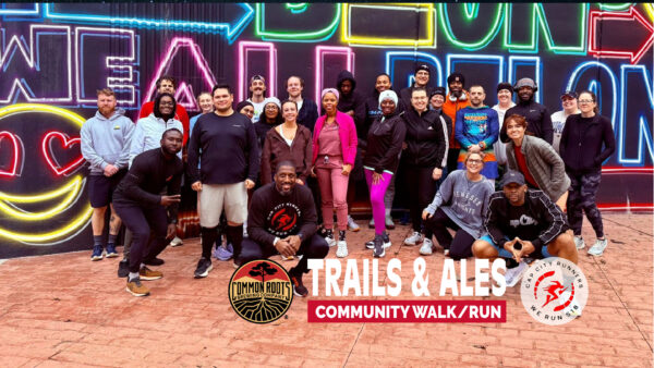 Runners Posing infront of a mural in Albany