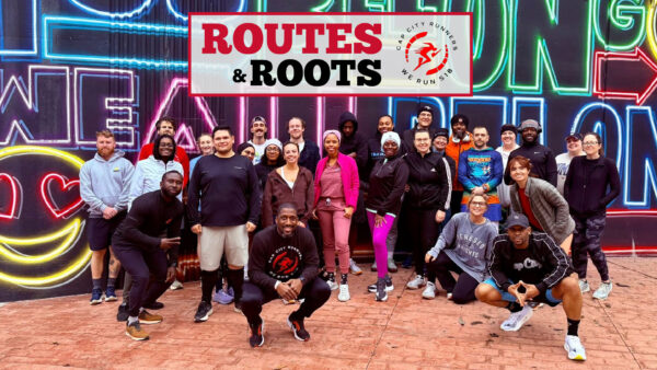 Runners Posing infront of a mural in Albany